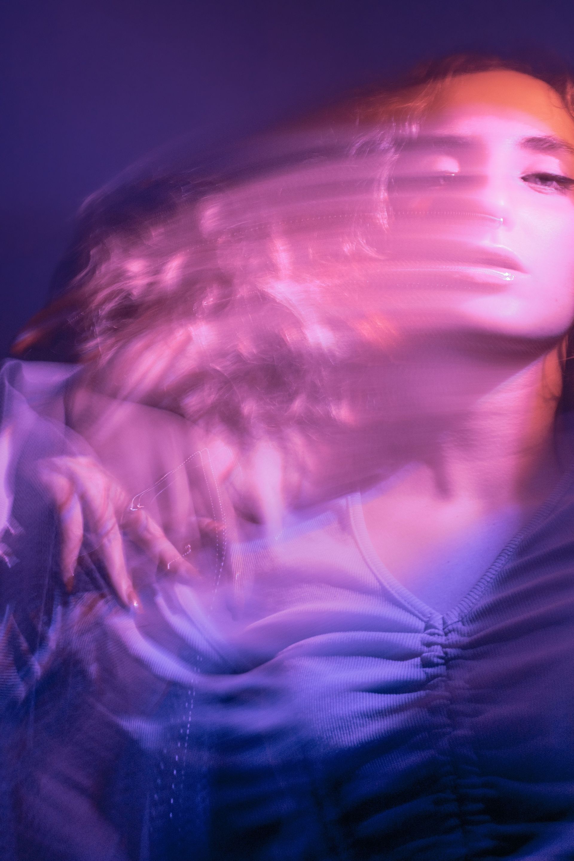 Vivid blurred portrait photography showcasing motion and vibrant colors with an artistic flair.